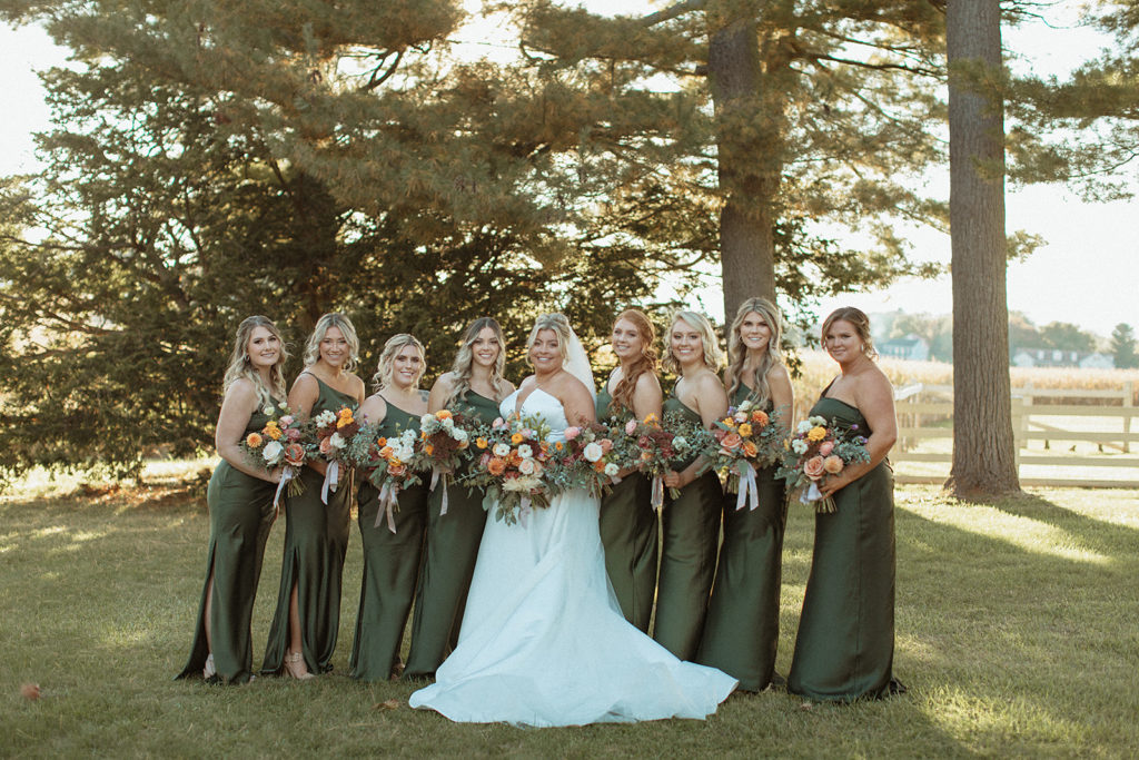Wedding at Bowling Brook Mansion with bride standing with her bridesmaids who are in emerald green bridesmaids dresses captured by Charlottesville wedding photographer