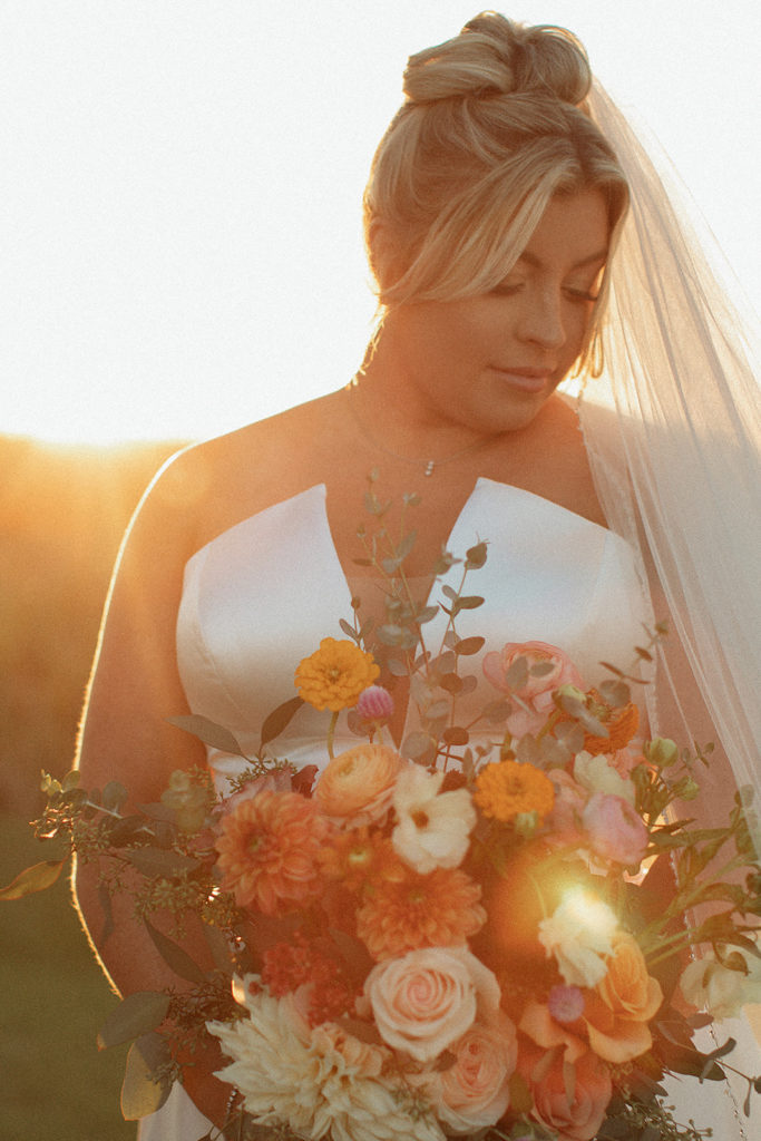 retro bridal photography with Charlottesville wedding photographer with bride holding her fall wedding bouquet at sunset 