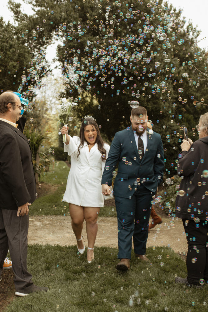 Charlottesville Wedding Photographer | Couples walking down the aisle in a bubble maze celebrating their marriage