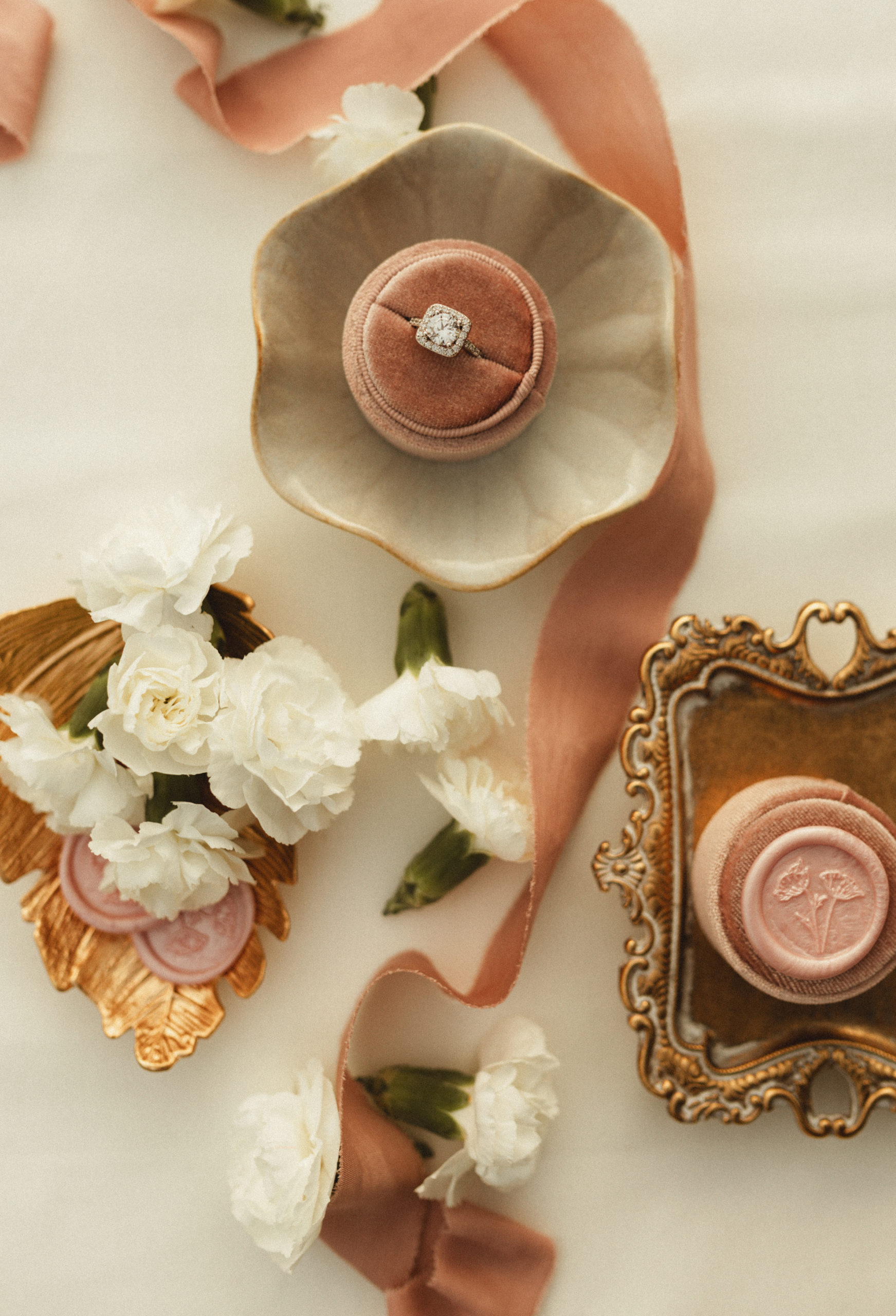 wedding details laid out in an elegant fashion in blush pink details 