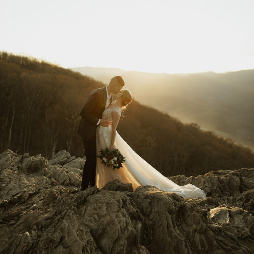 mountain elopement in Shenandoah with bride and groom kissing at sunset on top of a mountain captured by Virginia wedding photographer