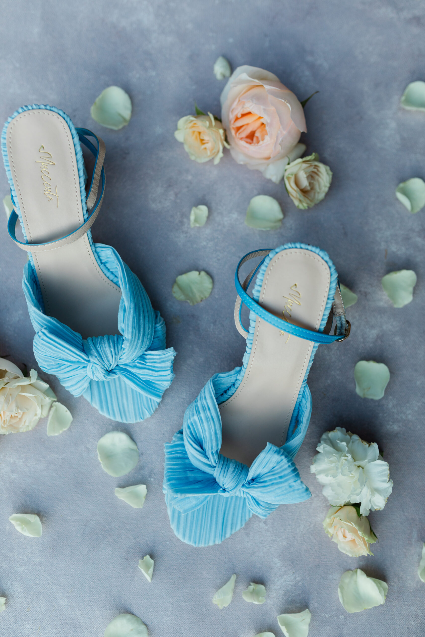 Blue high heel shoes with flowers surrounding it for a wedding at The Granary at Valley Pike