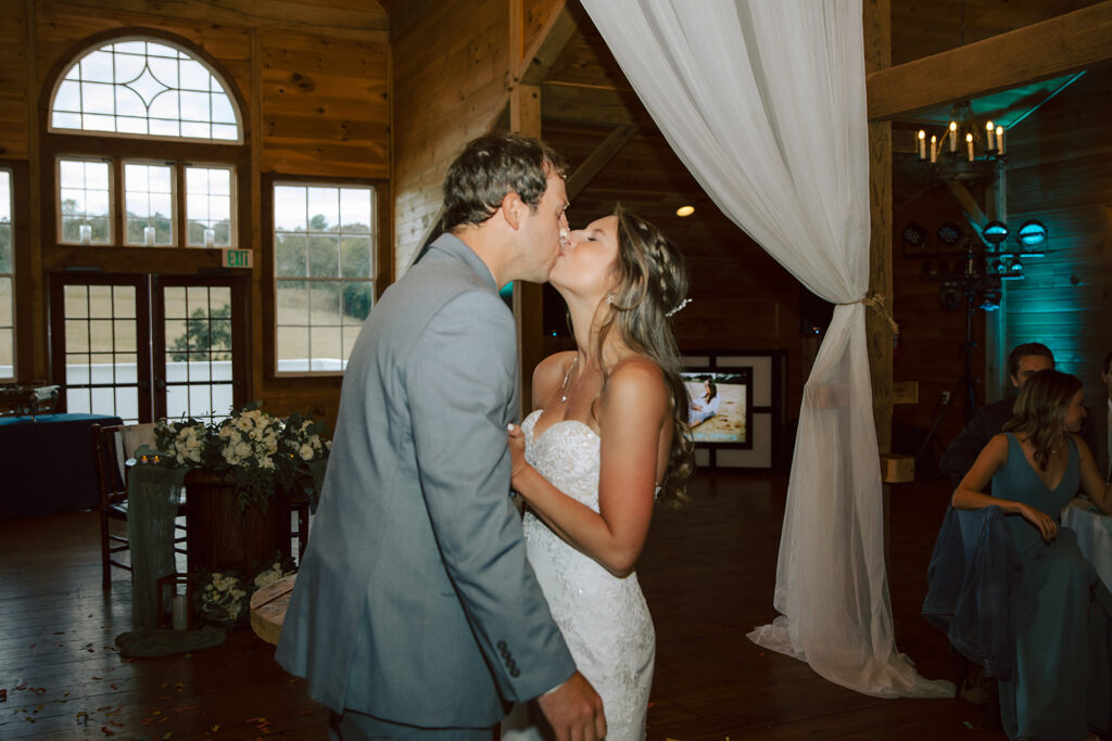 Stone Ridge Hollow Bride and Groom Kissing after cutting the cake