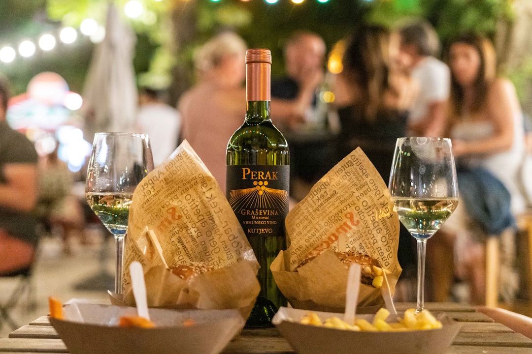 a bottle of wine and two glasses of wine on a table