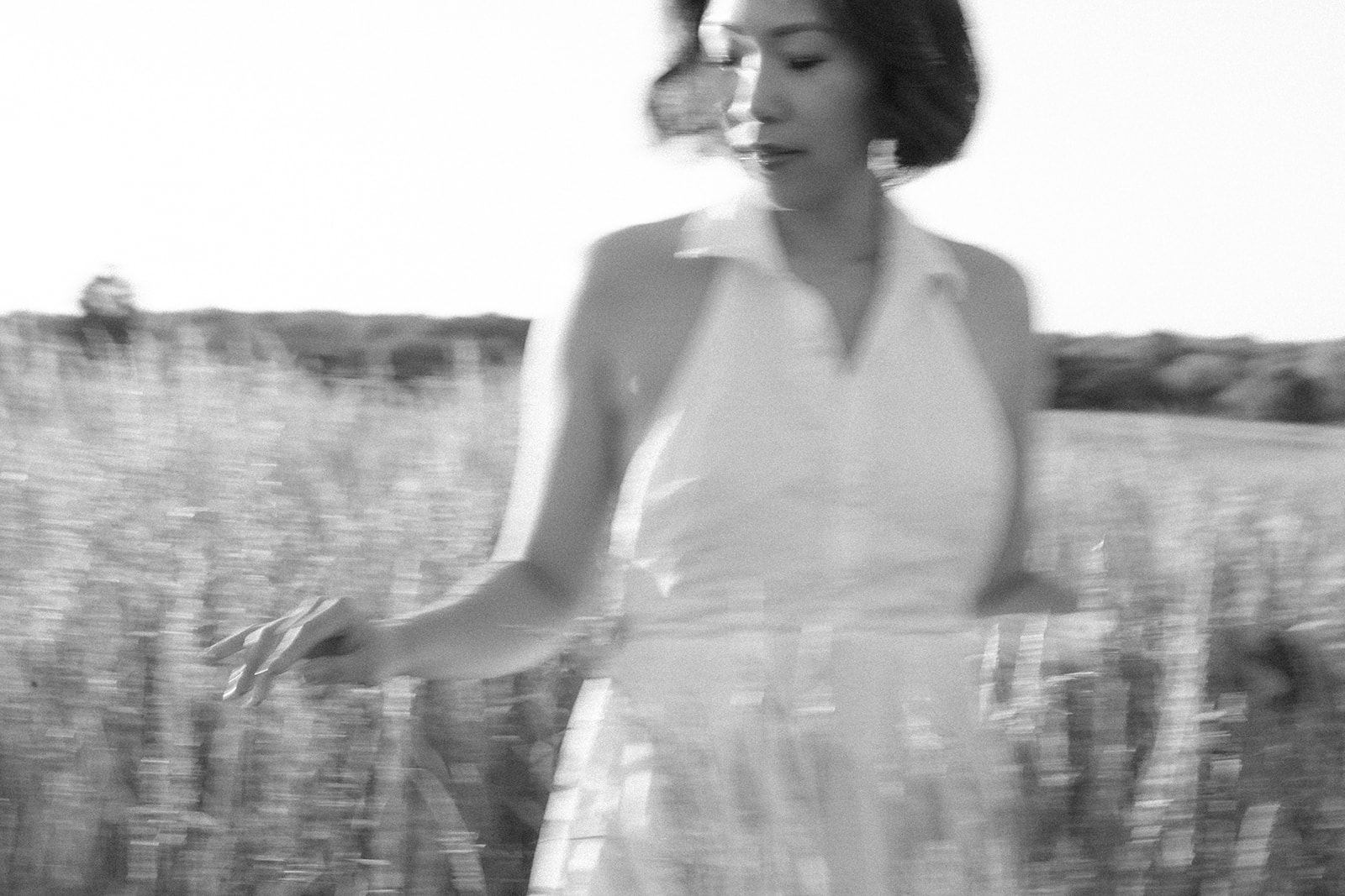 Kim at Manassas Battlefield Park in a white dress, radiating joy and beauty during the photoshoot.