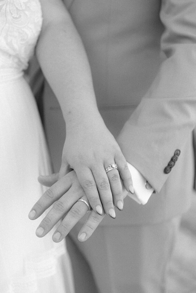 A close-up of the couple's hands showing their wedding rings, symbolizing their intimate elopement in Acadia National Park.