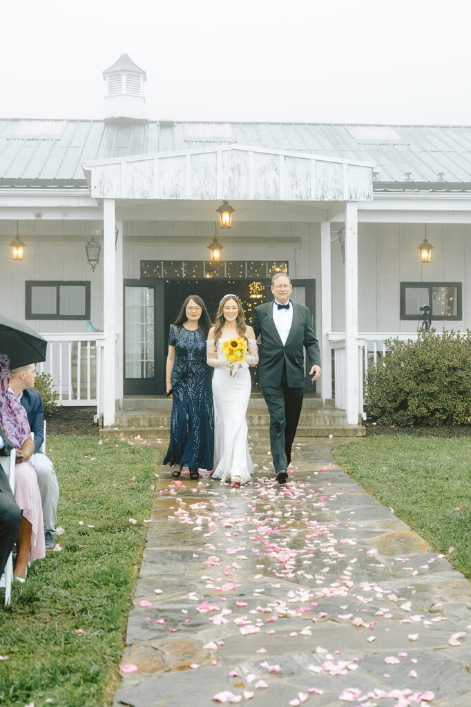 Bride with parents walking down the aisle at Bluemont Vineyard for their wedding