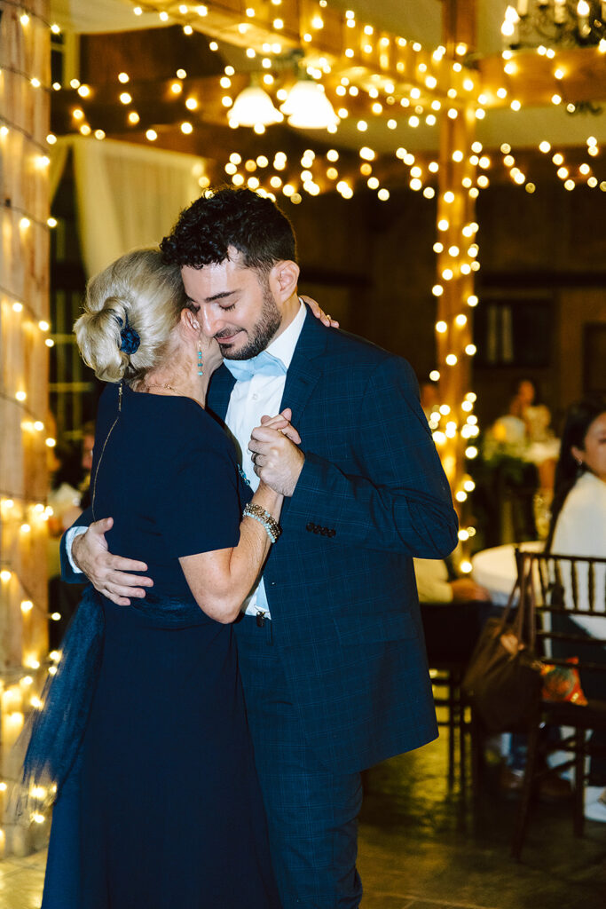 Groom and mom dancing together at The Stable at Bluemont Vineyard