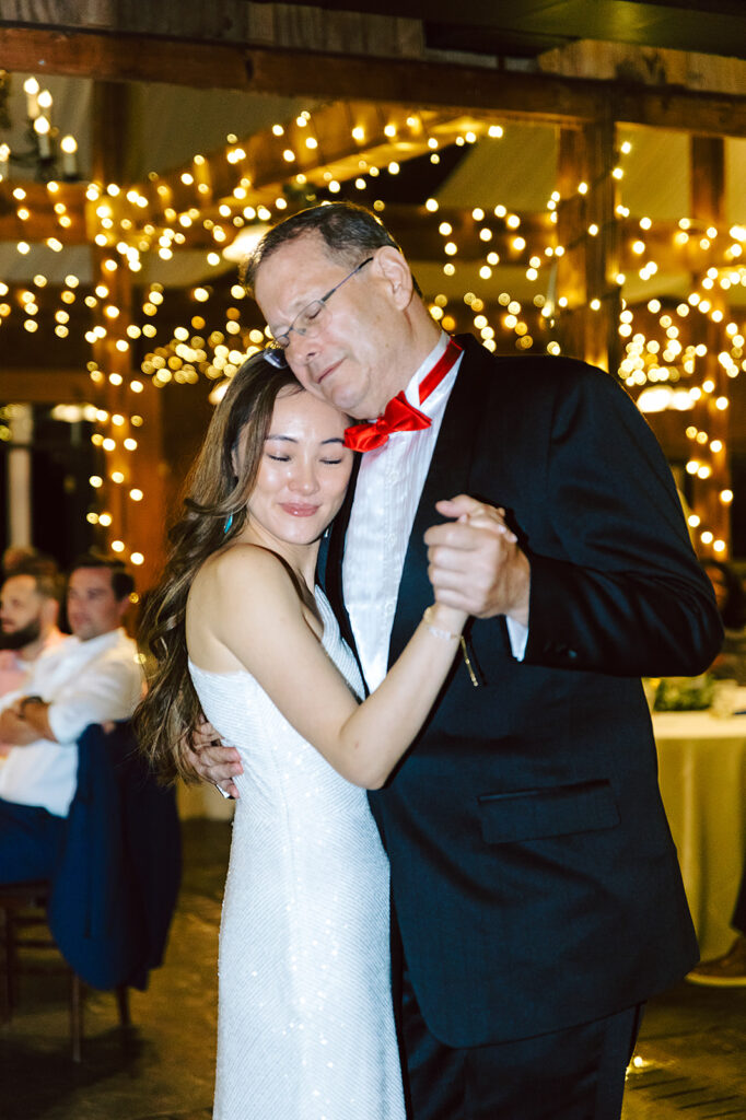 Bride and dad dancing together at The Stable at Bluemont Vineyard