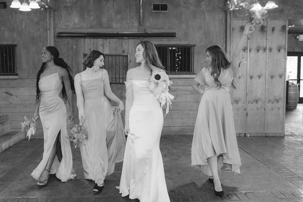 Wedding party posing together indoors at Bluemont Vineyard with vibrant blue dresses and yellow flowers creating a cheerful atmosphere.