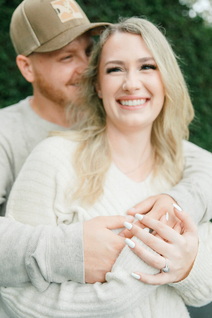 Close-up of a couple smiling and embracing during their engagement session at Drumore Estate.